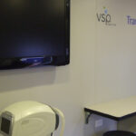 Interior of vision clinic vehicle with table, TV, and equipment
