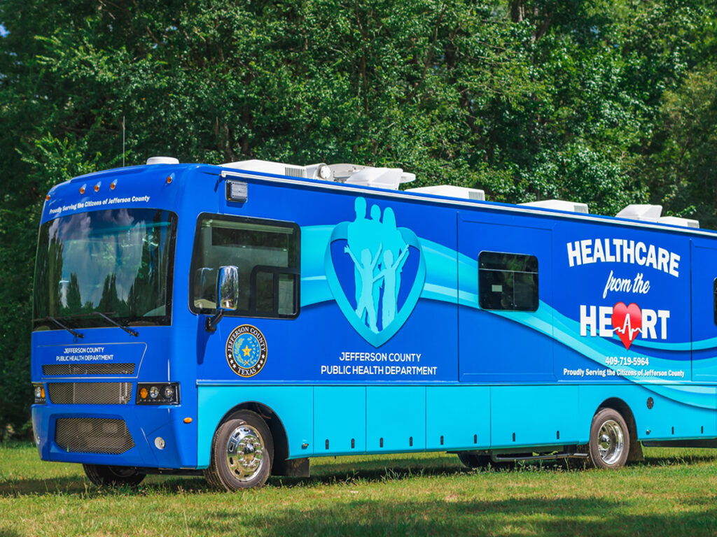 Front three-quarter view of a medical motorcoach called Healthcare from the Heart