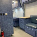 Sprinter medical van interior with blue cabinets, seat, and counter