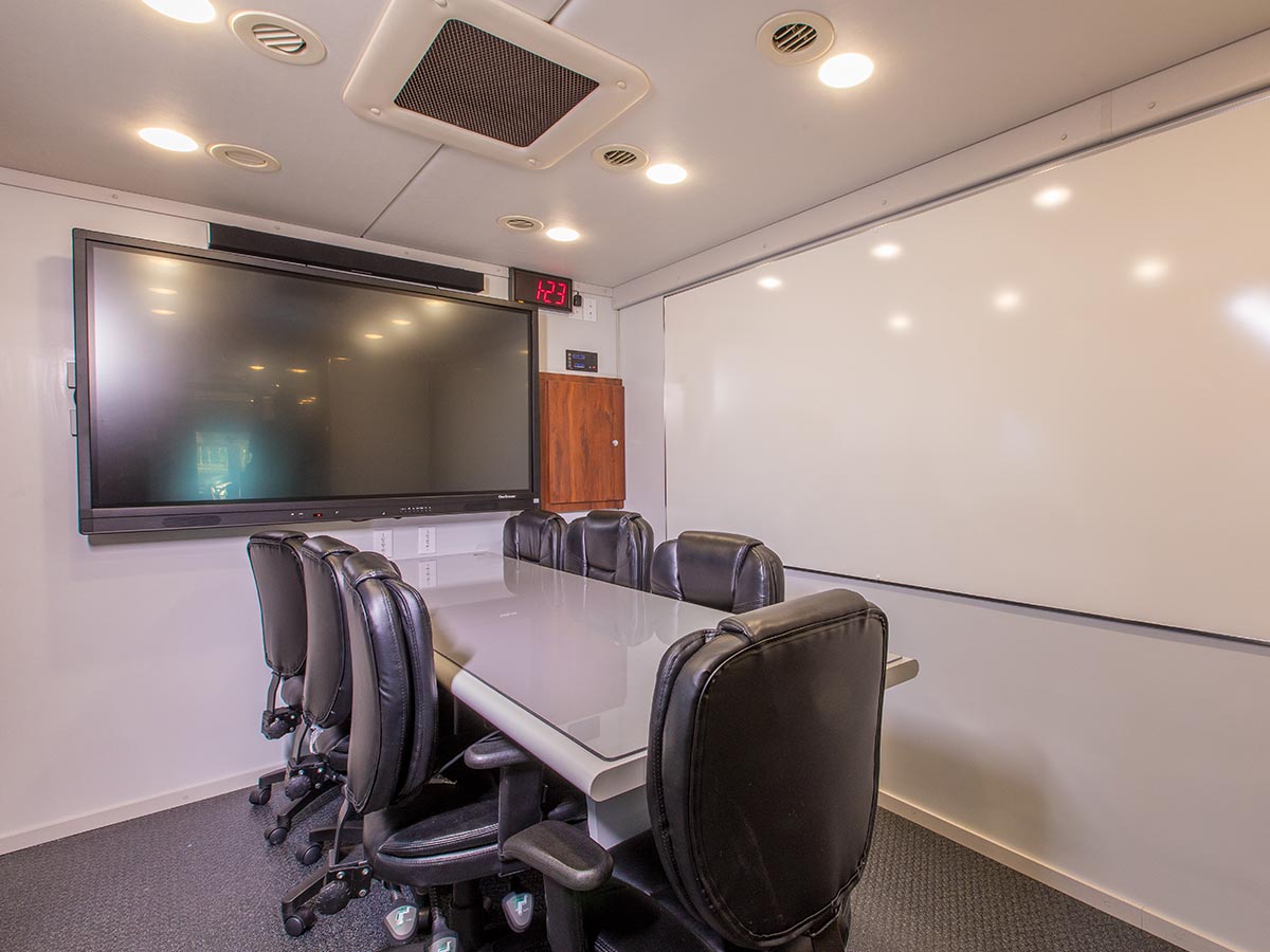 An image of a conference room with  a big screen tv