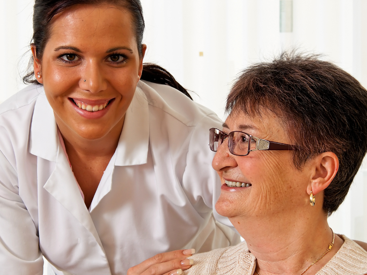 A female nurse smiling with a patient