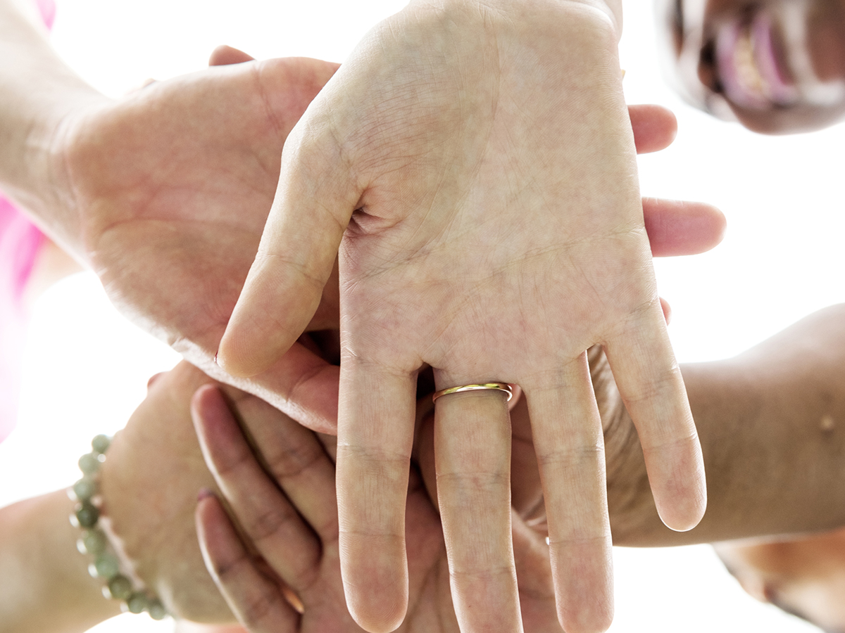 Women with their hands in a circle