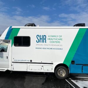 White, green, and blue SHR mobile healthcare clinic