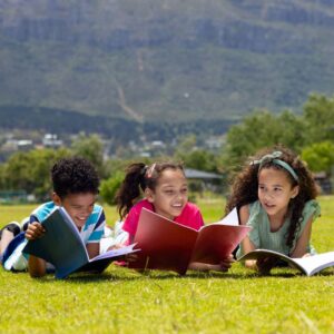 kids reading in grass