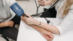 doctor taking patient's blood pressure
