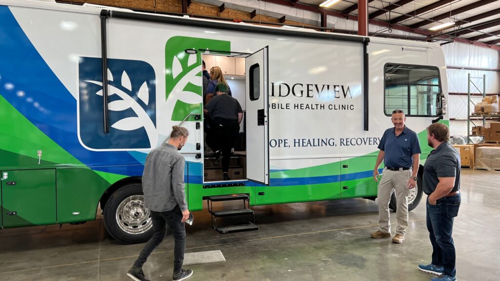 People walking into their new mobile medical unit